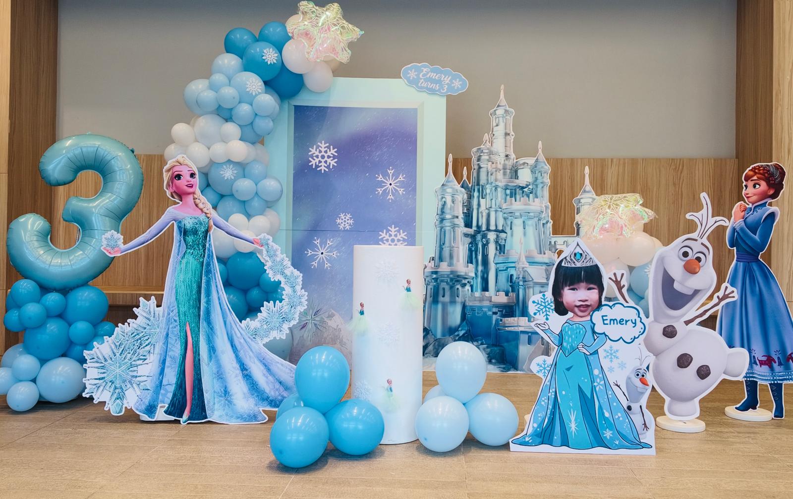 Large Frozen birthday decoration with castle backdrop and Elsa character cut-outs